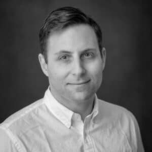 Man in white shirt looking straight into camera