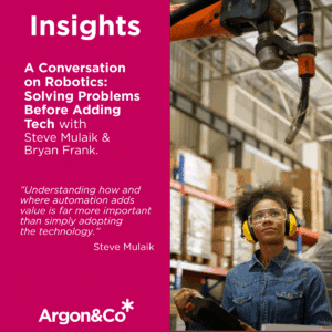 Robot in a warehouse with a woman with headphones on and promoting a short video for Argon & Co on automation